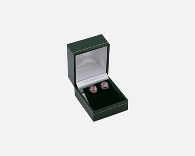 Lot 70 - A pair of oval ruby and diamond set halo stud earrings, set in gold-plated silver.