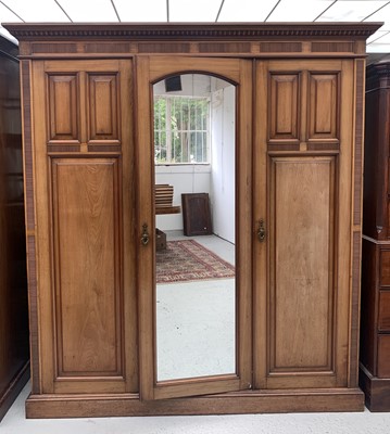 Lot 3087 - A high Victorian walnut triple wardrobe, with...