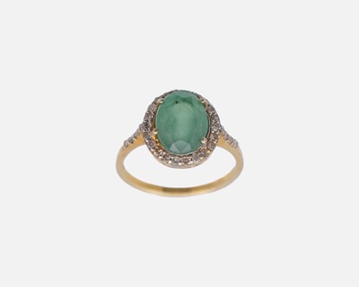 Lot 96 - A silver-gilt emerald and diamond cluster ring with diamond set shoulders.