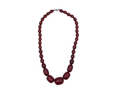 Lot 60 - A cherry amber style bakelite graduated oval bead necklace.
