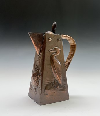 Lot 131 - A Newlyn copper hot water jug, repousse...