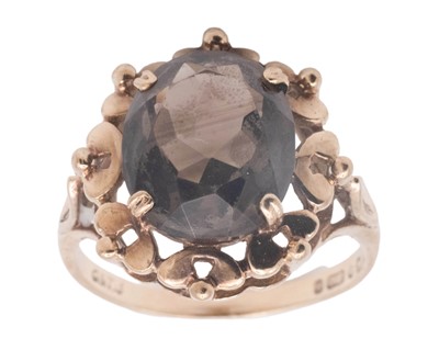 Lot 64 - A 1960's 9k oval cut smokey quartz set dress ring.