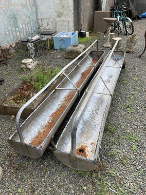 Lot 7 - A pair of galvanised metal sectional feeding...
