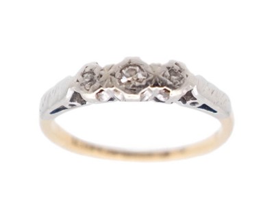 Lot 103 - An 18k and platinum diamond-set three-stone ring.