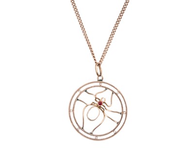 Lot 27 - A 9k rose gold spider pendant, set with rubies and pale blue paste, on a 9k neck chain.