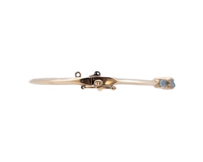 Lot 16 - An attractive 9k hallmarked gold oval cut aquamarine and diamond set hinged bangle.