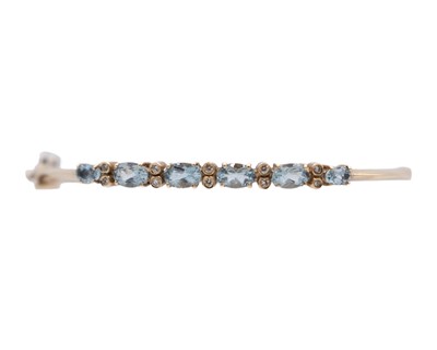 Lot 16 - An attractive 9k hallmarked gold oval cut aquamarine and diamond set hinged bangle.