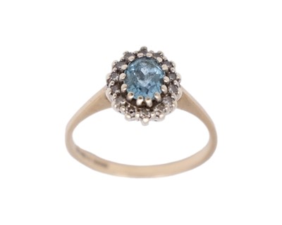Lot 108 - A 9k hallmarked gold oval blue topaz and diamond set cluster ring.