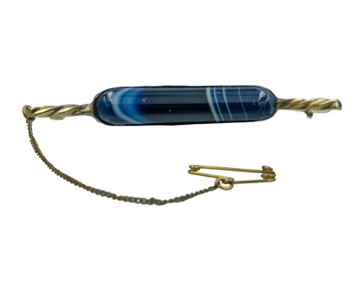 Lot 144 - A 9k gold-banded agate brooch.