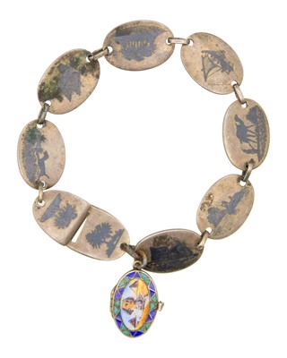 Lot 138 - An Egyptian silver niello bracelet with an enamel-decorated locket in the form of a basket.