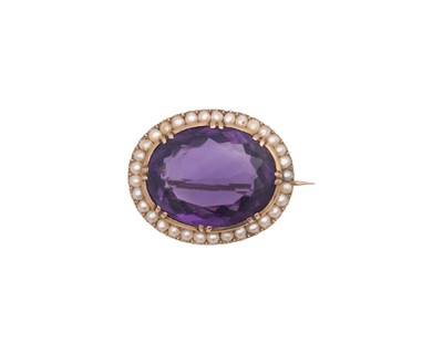 Lot 26 - A Victorian oval cut amethyst and seed pearl set gold brooch.
