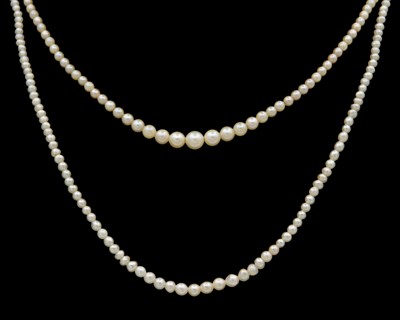 Lot 84 - Two fine graduated pearl necklaces, strung to silver clasps.