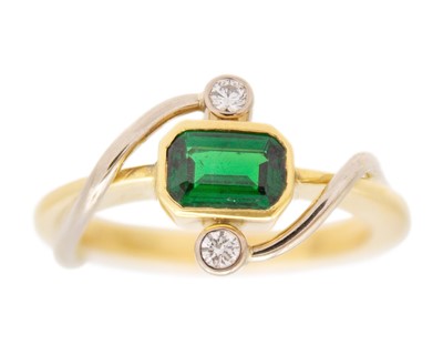 Lot 74 - A modern 18k yellow and white gold, emerald cut chrome diopside and diamond set ring.