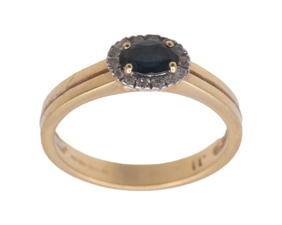 Lot 167 - A modern 18k diamond and oval cut teal sapphire set cluster ring.