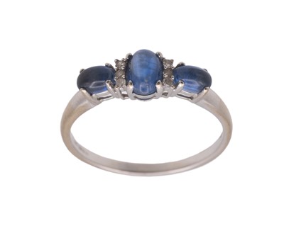 Lot 171 - A modern 9k white gold oval cabochon blue kyanite and diamond set ring.