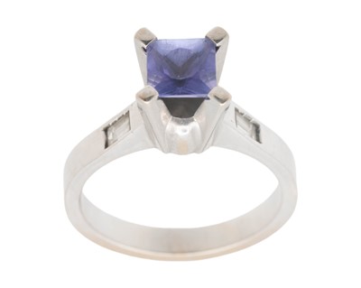 Lot 75 - An 18k white gold princess cut Tanzanite and diamond set ring.