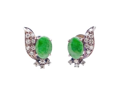Lot 86 - A pair of 14k (tested) white gold jadeite and pavé set diamond stud earrings.