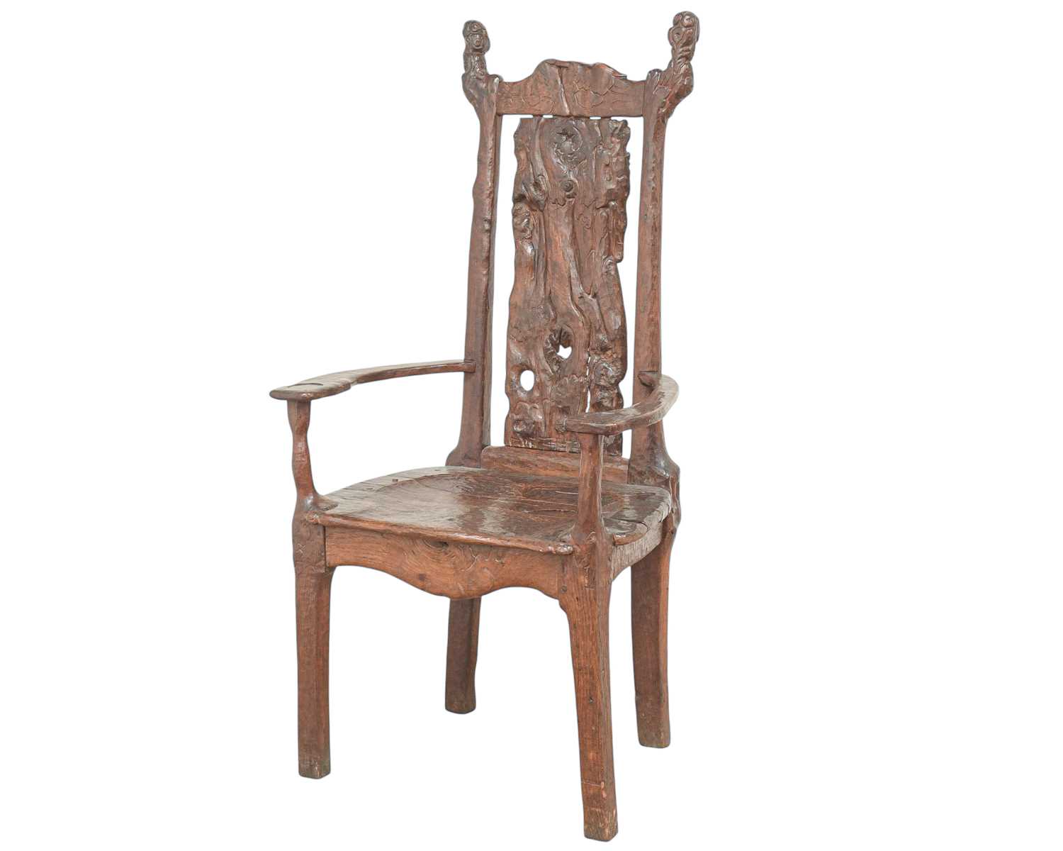 Lot 41 - A remarkable carved oak pegged elbow chair.