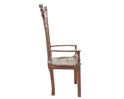 Lot 41 - A remarkable carved oak pegged elbow chair.
