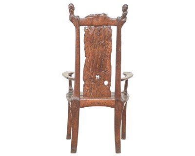 Lot 41 - A remarkable carved oak pegged elbow chair.