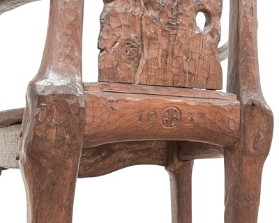 Lot 41 - A remarkable carved oak pegged elbow chair.