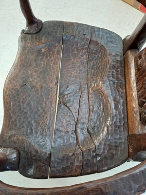Lot 41 - A remarkable carved oak pegged elbow chair.