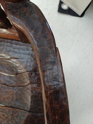 Lot 41 - A remarkable carved oak pegged elbow chair.