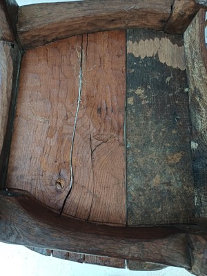 Lot 41 - A remarkable carved oak pegged elbow chair.