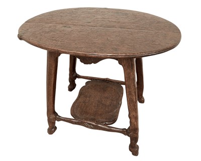 Lot 38 - An unusual carved oak two tier side table.