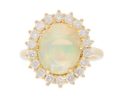 Lot 96 - A 9k yellow gold cluster ring set with cabochon opal.