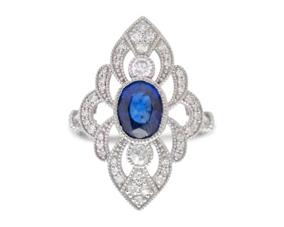 Lot 98 - A platinum 950 ring set with an oval sapphire and diamonds.