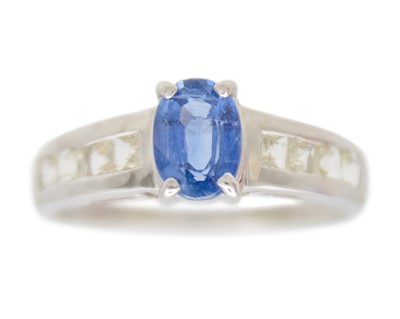 Lot 122 - A 9k white gold ring set with oval kyanite and white sapphires.
