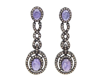 Lot 142 - A pair of striking tanzanite and diamond silver long drop earrings.