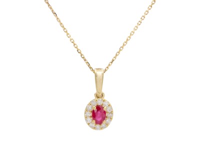 Lot 161 - A 9k yellow and gold oval ruby and round brilliant cut diamond cluster pendant.