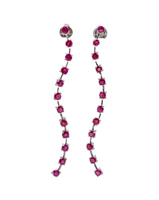 Lot 88 - A pair of 14k white gold ruby set drop earrings