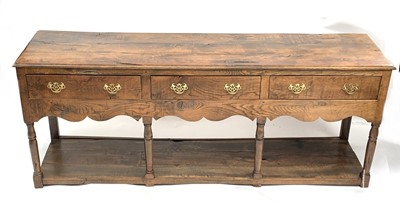 Lot 3123 - An oak dresser base, George III style, fitted...