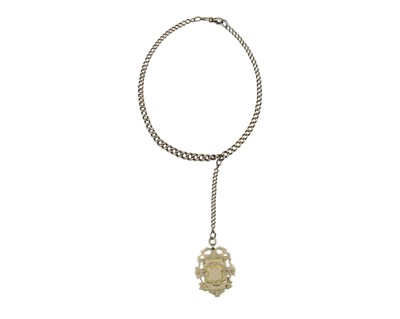 Lot 550 - A heavy 9k gold graduated curb-link Albert watch chain with armorial crest fob.