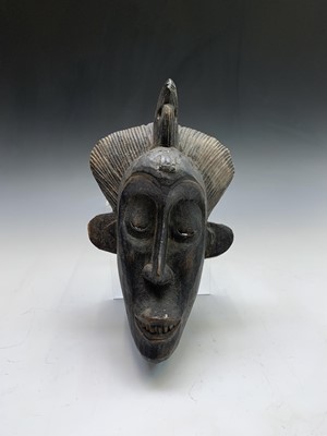 Lot 44 - A tribal carved softwood mask of slender form....