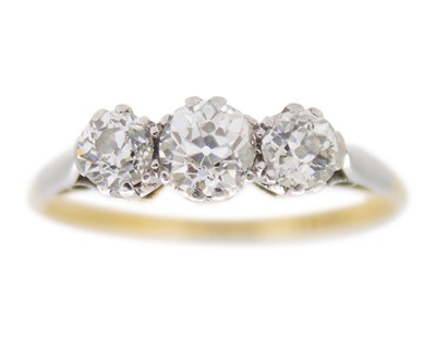 Lot 178 - An 18k yellow and white gold old mine cut diamond set three-stone ring.