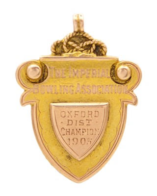 Lot 595 - A 15k yellow and rose gold shield watch fob.