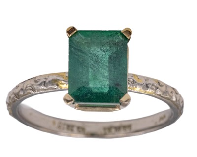 Lot 159 - A 1.6ct (estimated) emerald-cut emerald, set in a 14k and platinum ring.