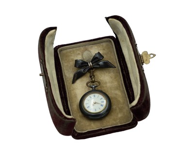 Lot 534 - A Swiss gun metal cylinder fob watch, with bow brooch, within original burgundy velvet travel case.