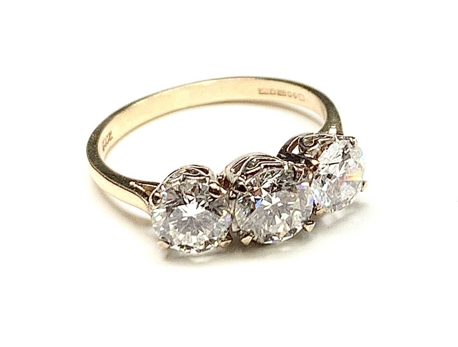 Lot 2342 - A good three stone diamond ring totaling...