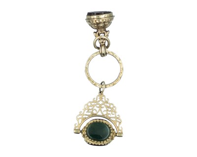 Lot 591 - Two gold small watch fob seals, on a gold split ring.