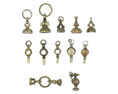 Lot 561 - A collection of 19th-century gold-plated pocket watch fob seals and watch winder keys.