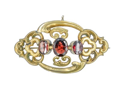 Lot 174 - A Victorian gold and garnet set openwork brooch.