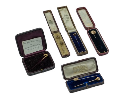 Lot 194 - A selection of seven gold stick-pins, within stick boxes.