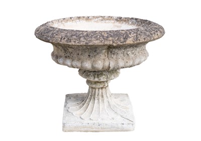 Lot 759 - A composition stone garden urn.