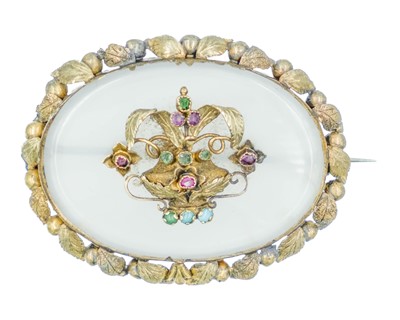 Lot 214 - A Victorian gold chalcedony brooch, the center with a vase of flowers set with emerald, ruby & turquoise.
