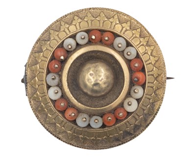 Lot 216 - A Victorian gold Etruscan Revival target brooch, set with coral beads and seed pearls.